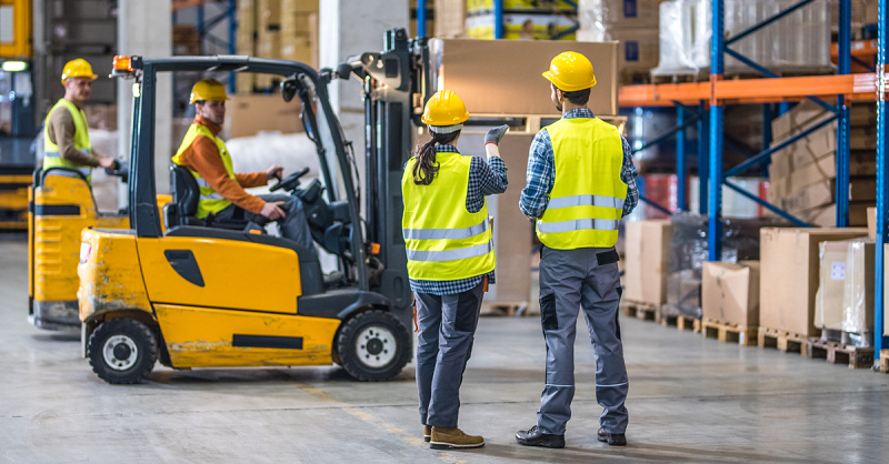 Men & Women using a forklift.