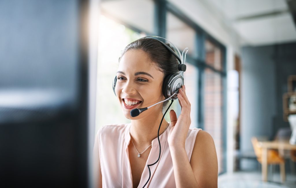 a women using head set on computer