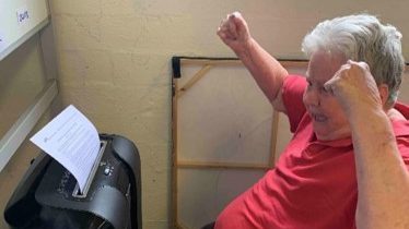 Person cheering using shredder.