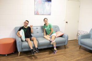 2 people sitting on the couch happy