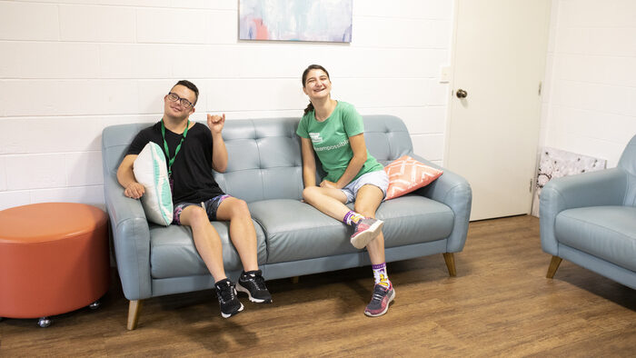 2 people sitting on the couch happy