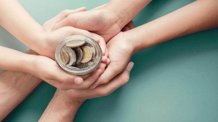 People holding coin jar