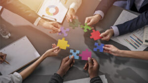 Holding puzzle pieces and trying to connect them together.