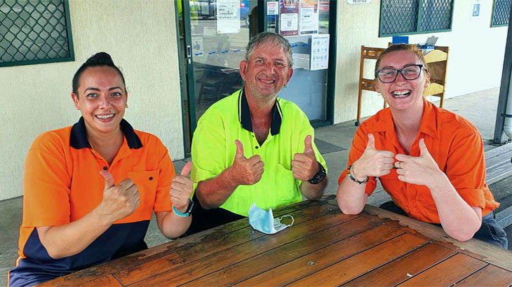 Happy people working sitting around table