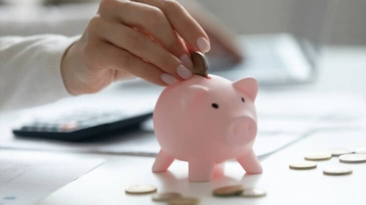 Worker putting money in piggybank