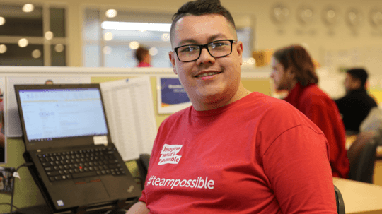 Photo of Brandon in 2020 at his desk.