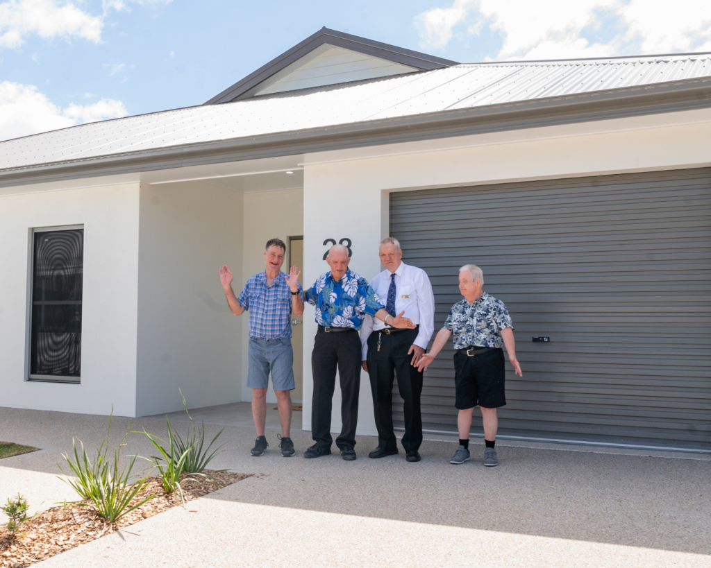 4 men standing out side home
