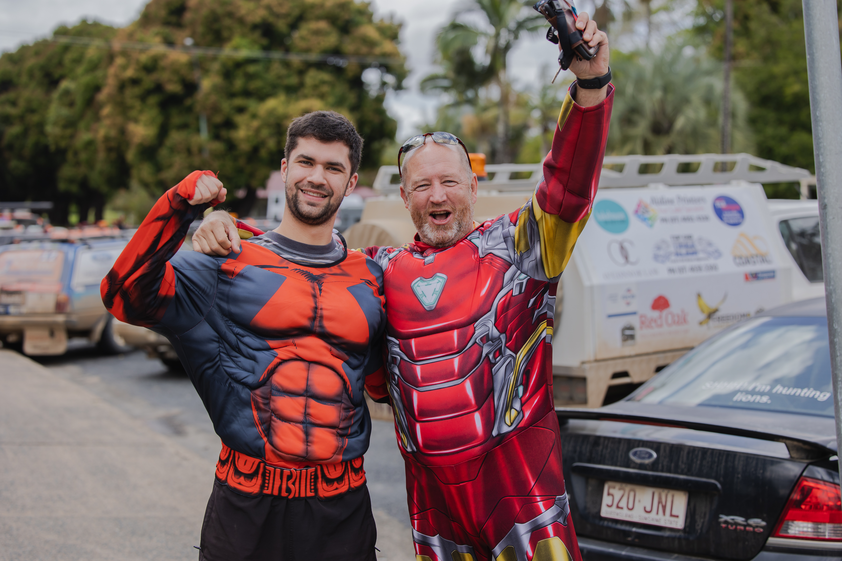 2 Men dressed up in costumes and looking excited.