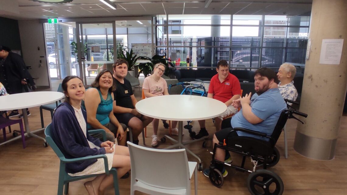 Customers at Bowen Hills with a smile sitting at the table.