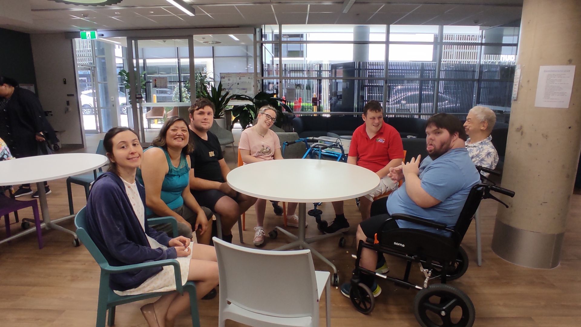 Customers at Bowen Hills with a smile sitting at the table.